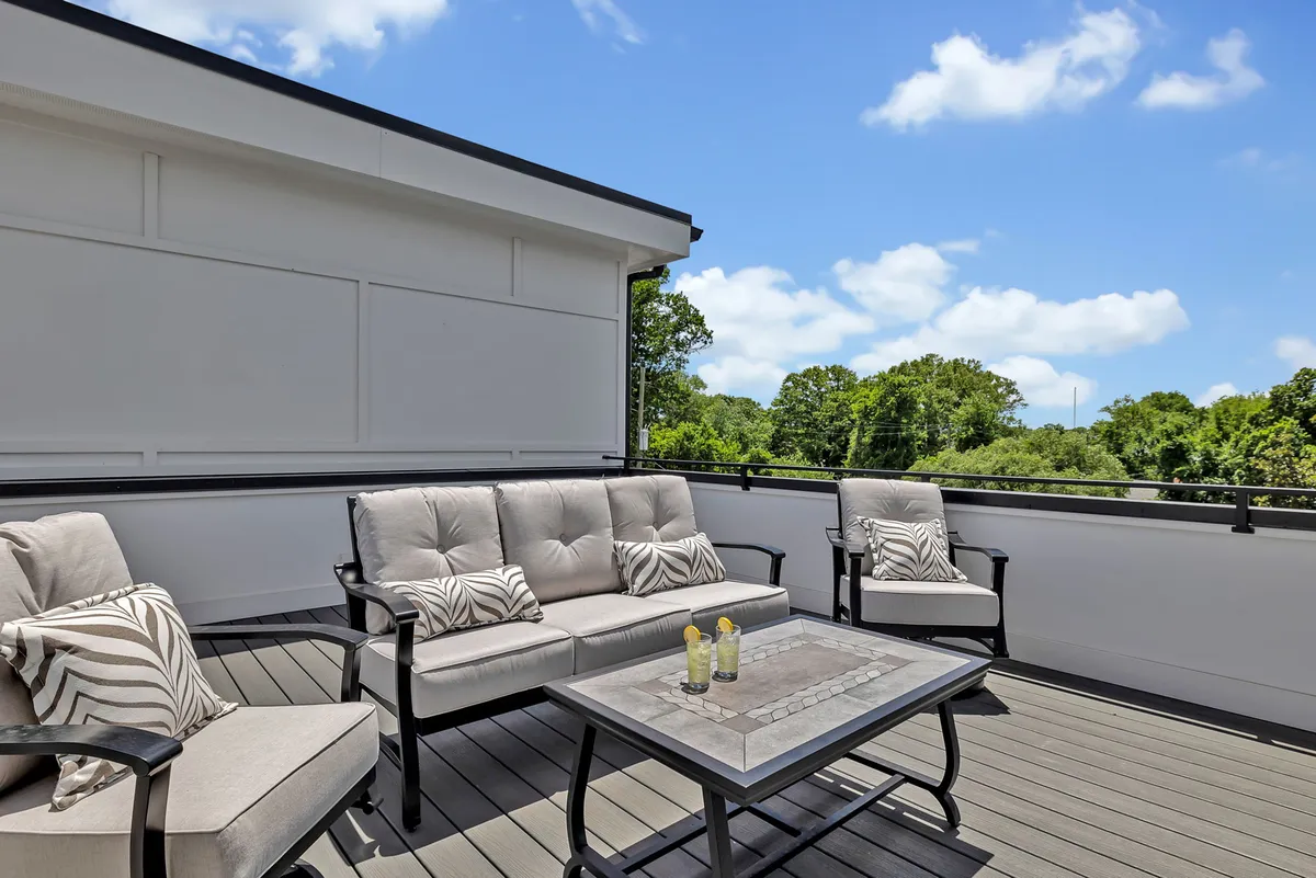 An inviting outdoor setting with cozy seating and a coffee table, surrounded by lush greenery. The space exudes tranquility and is perfectly suited for relaxed conversation, morning coffee, or unwinding with friends as the sun sets.