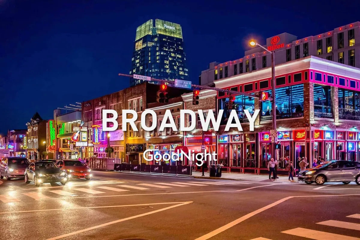 A vibrant Nashville street scene at night, filled with neon signs, people walking, cars, and buildings, capturing the lively atmosphere of the city's nightlife and entertainment district.
